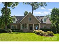 Charming brick home with a manicured lawn and beautiful landscaping at 901 Hartford Ave, Charlotte, NC 28209