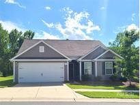 Charming single-story home features a two-car garage and well-maintained lawn at 1195 Winding Creek Rd, Salisbury, NC 28146