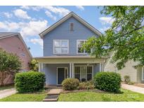 Charming two-story home featuring a cozy front porch and well-maintained landscaping at 1825 Stroud Park Ct, Charlotte, NC 28206