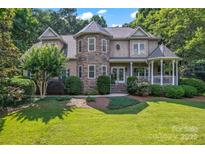 Beautiful home featuring a stone turret, manicured landscaping, and a charming covered porch at 2541 Penngate Dr, Sherrills Ford, NC 28673