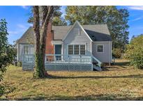 Charming single-story home featuring a cozy front porch, brick chimney, and inviting curb appeal at 4315 Gibbon Rd, Charlotte, NC 28269