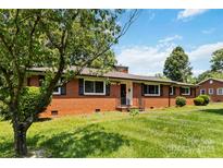 Charming brick home featuring a well-manicured lawn and classic architectural details at 5111 Tewkesbury Rd, Charlotte, NC 28269