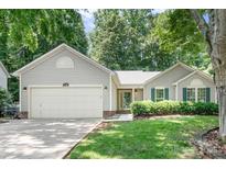 Charming single-story home with an attached two-car garage and a well-manicured front yard at 5400 Groveton Ct, Charlotte, NC 28269