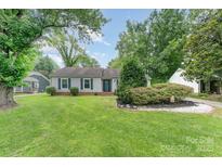 Charming home featuring a well-manicured front lawn, mature trees, and tasteful landscaping at 706 Hammermill Ct, Charlotte, NC 28270