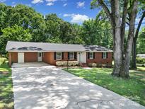 Charming brick ranch-style home with a well-manicured lawn and a long driveway at 967 Hilldale Dr, Lancaster, SC 29720