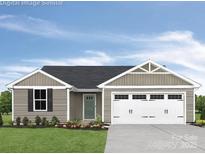 Charming single-story home showcasing a two-car garage and a neatly maintained lawn at 10127 Florentine Way, Charlotte, NC 28214