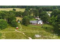 Expansive aerial view of a charming two-story home with a well-maintained lawn and mature trees at 1238 Carl Allen Rd, Edgemoor, SC 29712
