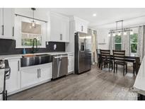 Bright eat-in kitchen with stainless appliances and wood laminate floors at 1238 Carl Allen Rd, Edgemoor, SC 29712