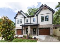 Beautiful two-story townhouse with a modern design, landscaped front yard, and stylish architectural details at 1724 Dallas Ave, Charlotte, NC 28205