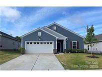 Charming single-Gathering home featuring a two-car garage, well-kept lawn, and inviting front entrance at 185 Willow Valley Dr, Mooresville, NC 28115