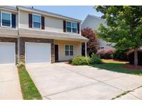 Charming townhome with stone accents, a one-car garage, and a well-maintained front yard at 2180 Shady Pond Dr, Clover, SC 29710