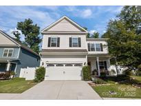 Charming two-story home with well-maintained landscaping, garage, and inviting entrance at 229 Cramerton Mills Pkwy, Cramerton, NC 28032