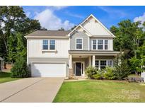 Charming two-story home featuring a two-car garage, well-manicured lawn, and delightful curb appeal at 3212 Gilroy Dr, Fort Mill, SC 29707