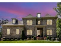 Beautiful brick two-story home with manicured lawn and inviting front entrance at 4005 Capullo Ct, Matthews, NC 28104