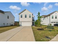 Charming two-story home with a well-manicured lawn and a spacious two-car garage at 4013 Southern Pine Dr, Mount Holly, NC 28120