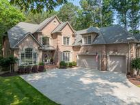 Charming two-story brick home with a spacious driveway and well-manicured lawn at 4075 Crepe Ridge Dr, Denver, NC 28037