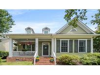 Charming home featuring a welcoming front porch, brick stairs, and light green siding at 4115 Birkshire Hts, Fort Mill, SC 29708
