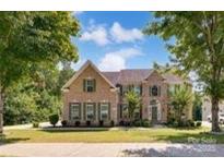 Charming brick two-story home with manicured lawn and mature trees, offering classic curb appeal at 4201 Amber Leigh Way Dr, Charlotte, NC 28269