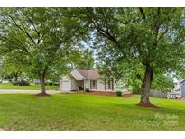 Charming single-story home with a well-manicured lawn and mature trees at 510 Sw Viking Sw Pl, Concord, NC 28025