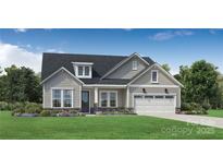 Charming home featuring a well-manicured lawn, inviting entrance, and an attached two-car garage at 5475 Spruce St # 256, Indian Land, SC 29707