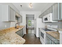 Spacious kitchen featuring granite counters, modern appliances, and tiled floor at 10867 Garden Oaks Ln, Charlotte, NC 28273