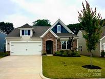 Charming home with stone accents, manicured lawn, and a two-car garage at 110 White Apple Way, Statesville, NC 28625