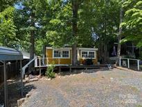 Cozy cabin surrounded by lush trees and greenery, offering a peaceful retreat at 120 Starboard Trl, Mount Gilead, NC 27306
