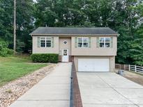 Charming two-story home with a spacious driveway and well-maintained landscaping at 125 Shenandoah Loop, Troutman, NC 28166