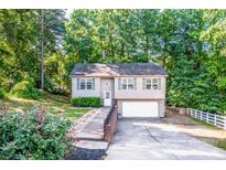 Charming home featuring a well-manicured lawn and an attached garage at 125 Shenandoah Loop, Troutman, NC 28166
