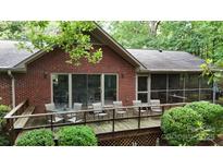 Beautiful brick home featuring an outdoor seating area on a spacious wooden deck at 139 Cricket Creek Dr, Cherryville, NC 28021