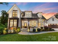 Beautiful two-story home with a landscaped yard and a detached two-car garage at 175 Mcleod Ave, Belmont, NC 28012