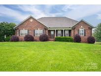 Charming brick home with lush lawn and well-manicured landscaping creates curb appeal at 2817 Long Cir # 1, Iron Station, NC 28080