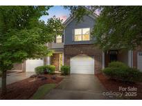 Charming two-story townhome with a brick facade and a one-car garage at 3237 Yarmouth Ln, Gastonia, NC 28056