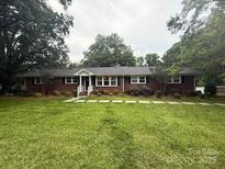Charming single-story brick home with a well-manicured lawn and mature trees at 3250 Celanese Rd, Rock Hill, SC 29732