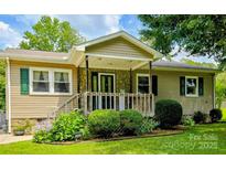 Charming single-story home featuring a stone facade, covered porch, and well-maintained landscaping at 332 Daybrook Dr, Landis, NC 28088