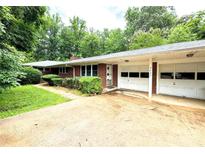 Charming brick home featuring an attached two-car garage and a lush green lawn at 3420 Long Ferry Rd, Salisbury, NC 28146