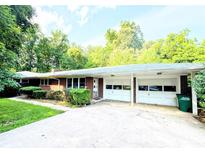 Charming brick ranch home with attached two-car garage and lush green landscaping at 3420 Long Ferry Rd, Salisbury, NC 28146