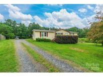 Charming single-story home with a gravel driveway and well-maintained lawn and mature landscaping at 4373 Wentz Rd, Maiden, NC 28650