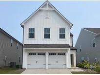 Charming two-story home featuring a white exterior, a two-car garage, and modern architectural details at 492 Switch St # 82 Ty, York, SC 29745