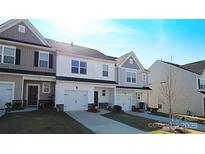 Charming townhome features a well-manicured lawn, one-car garage, and a welcoming exterior at 8177 Sheffield Dr, Terrell, NC 28682