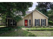 Charming single-Gathering home featuring a red front door, black shutters, and well-maintained landscaping at 8618 Rittenhouse Cir, Charlotte, NC 28270