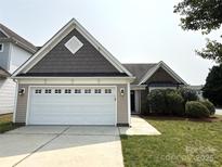 Charming single-story home with a well-manicured lawn and a two-car garage at 1423 Napa Nw St, Concord, NC 28027