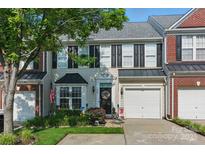 Charming townhome with neutral siding, black shutters, an attached garage, and manicured landscaping at 158 Snead Rd, Fort Mill, SC 29715