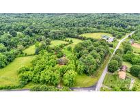 Expansive aerial view of wooded property with lush greenery surrounding a home and nearby buildings at 1783 Radio Station Rd, Newton, NC 28658