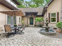 Charming exterior features a beautiful stone patio with fountain and outdoor seating area at 3394 Rainbow Dr, Waxhaw, NC 28173