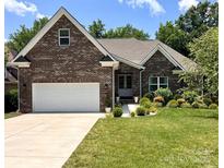 Charming brick home with a well-manicured lawn and a two-car garage in a beautiful neighborhood at 3633 Longpond Ln, Monroe, NC 28110