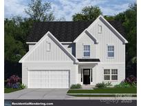 Charming two-story home with a two-car garage, black roof, black door, and neutral-colored siding at 4028 Deerstone Ln # 23, Clover, SC 29710