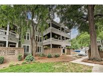 Charming three-story building with a brick facade and inviting landscaped garden with mature trees at 433-68 W 8Th St, Charlotte, NC 28202