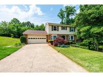 Charming two-story home featuring a spacious front yard and attached two-car garage at 5516 Northwood Dr, Hickory, NC 28601