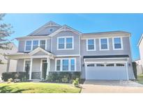 Charming two-story home with gray siding, a two-car garage, manicured lawn, and inviting front porch at 9419 Silverdale Ln, Charlotte, NC 28269